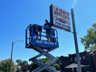 A Plus Auto Care getting the sign ready for business