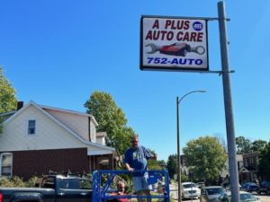 A Plust Auto Care sign open for business